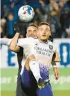  ?? PAUL CHIASSON/AP ?? CF Montreal defender Rudy Camacho hangs onto Orlando City forward Ercan Kara as they battle for the ball during the first half on Sunday night in Canada.