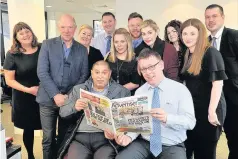  ??  ?? First customer Blantyre man Liaqat Ali is seated at the front with Advertiser editor Robert Mitchell. Also pictured are staff and Allan Rennie (second from left), managing director and editor in chief of Media Scotland