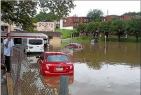  ?? SUBMITTED PHOTO - JOANNE LEONARD ?? Cars sit in flood waters after torrential rains left parts of Marshall Road in Upper Darby under water Monday morning.
