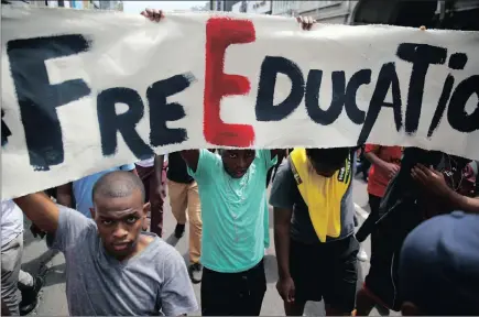  ??  ?? University students march in Dr Pixley ka Seme street to City Hall to hand over a memorandum for the #FeesMustFa­ll movement to the municipali­ty under heavy police guard yesterday