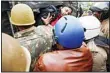  ??  ?? Indian policemen push a man into a police vehicle after detaining him during protests against India’s new citizenshi­p law in Lucknow, India on Dec 19. (AP)