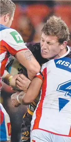  ?? Picture: GETTY IMAGES ?? TOUGH KNIGHT: Broncos forward Jarrod Wallace is crunched by the Newcastle defence last night.