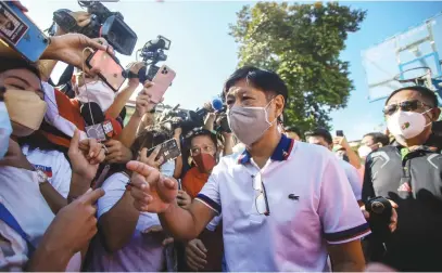  ?? Picture: AFP ?? MARKED. Philippine presidenti­al candidate Ferdinand Marcos Jr walks past the media after casting his vote at Mariano Marcos Memorial Elementary School in Batac, Ilocos Norte.