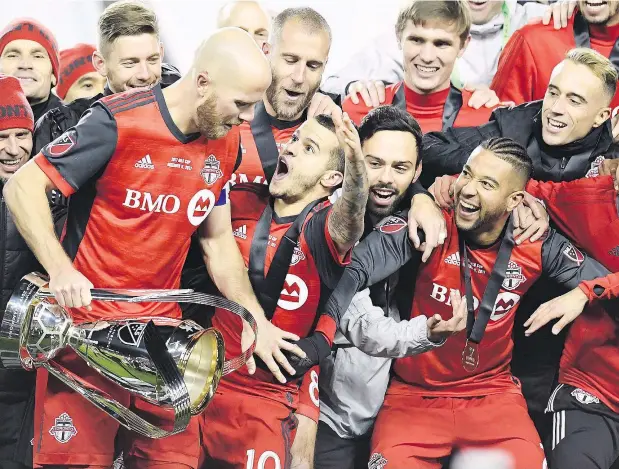  ?? — THE CANADIAN PRESS FILES ?? Toronto FC celebrates their win over the Seattle Sounders in the MLS Cup Final in Toronto in December of 2017. The team faces Vancouver in the first leg of the Canadian Championsh­ip Final tonight at B.C. Place.