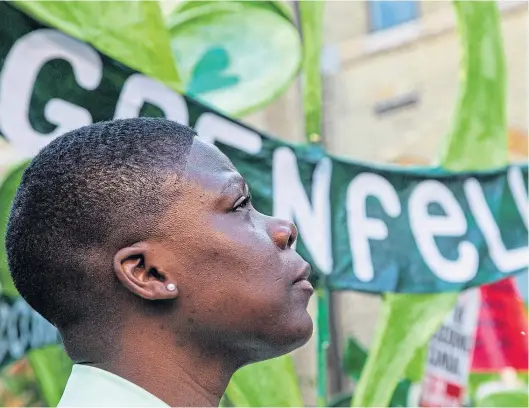  ?? ?? A woman attends the fifth anniversar­y of the Grenfell tower fire in London on June 14. The blaze claimed the lives of 72 residents