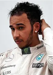  ??  ?? Despondent: Hamilton on the podium