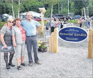  ?? SUBMITTED PHOTO ?? Barb Heath, Kay Killey and Scott Newman gather at the entrance of the Memorial Garden in South Brook. Newman made, donated and erected the sign.