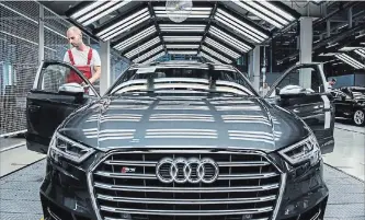  ?? AKOS STILLER BLOOMBERG NEWS ?? An employee performs a quality control check on the interior of an Audi S3 automobile. Many higher-end car companies have a variety of subscripti­on models in other markets, including allowing customers to switch between a number of vehicle options.