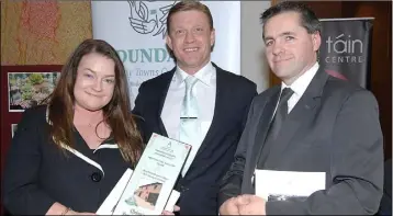  ??  ?? Annette and Gerard Quinn receiving the second prize in the Best Business premises for Quinn’s Funeral home from Michael Gunne, sponsor at the Improve Our town awards night.