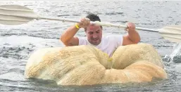  ?? Picture: Reuters ?? MAKING A SPLASH. A man paddles his pumpkin boat during the traditiona­l pumpkin race in Lohmar, Germany, this week.