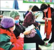  ?? PROVIDED TO CHINA DAILY ?? Below: Li Jingxin (right) from the Sailande Social Work Office demonstrat­es smartphone use to the elderly in Shijingsha­n district, Beijing.