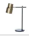  ??  ?? Left Atticus brass table lamp, $199, from Shut The Front Door. Below Noir candle, $75, from Abbey Rose Candles.