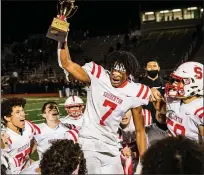  ?? JAMES BEAVER/FOR MEDIANEWS GROUP ?? Souderton’s Jalen White (7) shows his emotions as he raises the District 1-6A championsh­ip trophy after defeating Pennridge.