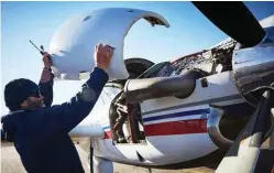  ??  ?? Airframe engineer Dan Hayes cleans and checks a plane engine before it heads off on the day’s first clinic visits to Wilcannia and White Cliffs, NSW.