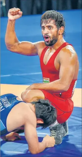  ?? PTI ?? Bajrang Punia gestures defeating Japan's Daichi Takatani in the 65kg wrestling final on Sunday.