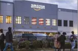  ?? AP file photo ?? People arrive for work at the Amazon distributi­on center in the Staten Island borough of New York on Oct. 25.