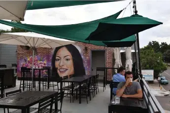  ?? Photos by Hyoung Chang, The Denver Post ?? Hiero Veiga’s mural of Bella Thallas can be seen at Denver’s Park Tavern and Restaurant, where Thallas celebrated her 21st birthday.