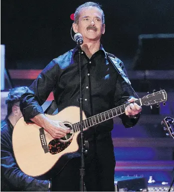  ?? PHOTOS: NICK PROCAYLO/PNG ?? Astronaut Chris Hadfield sings with the Barenaked Ladies on Wednesday at Rogers Arena.