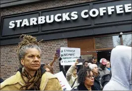  ?? MARK MAKELA / GETTY IMAGES ?? Michelle Brown, 50 (left), demonstrat­es outside a Starbucks last month in Philadelph­ia, where police arrested two black men who were waiting inside.