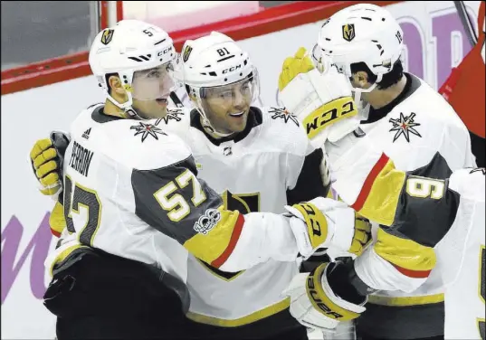  ?? Fred Chartrand The Canadian Press via AP ?? French-speaking Knights Jonathan Marchessau­lt, center, and David Perron, left, rejoice with teammate James Neal after Marchessau­lt’s goal in Ottawa, Ontario, last week against the Senators.