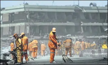  ?? RAHMAT GUL / ASSOCIATED PRESS ?? Municipal workers sweep a road in front of the German Embassy in Kabul, Afghanista­n, after a suicide attacker’s truck exploded in the capital city’s heavily guarded diplomatic quarter during morning rush hour Wednesday.