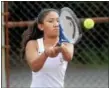  ??  ?? Vyda VanDenberg follows through on backhand during a fourth singles victory.