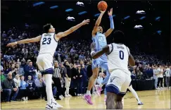  ?? MATT SLOCUM — THE ASSOCIATED PRESS ?? Creighton’s Trey Alexander, center, goes up for the go-ahead basket between Villanova’s Tyler Burton, left, and TJ Bamba during the final seconds on Saturday.