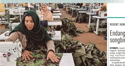  ?? AFP PIC ?? Women who lost their husband or relatives in the ongoing war in Afghanista­n with the Taliban stitching military uniforms at a factory in Kabul recently.