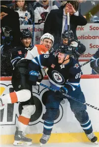  ?? JOHN WOODS/THE CANADIAN PRESS VIA AP ?? The Jets’ Nate Schmidt, right, and the Flyers’ Garnet Hathaway collide during the third period Jan. 13.