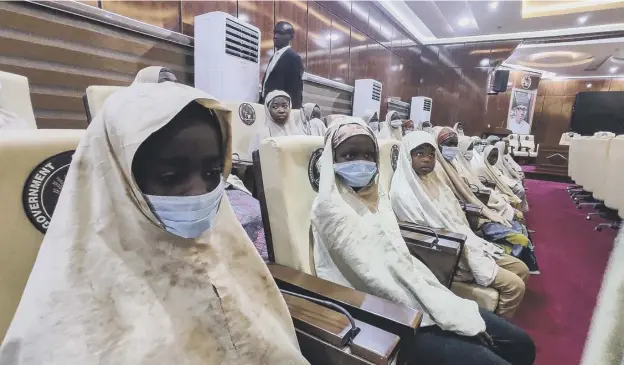  ??  ?? 0 A group of girls kidnapped from their boarding school in northern Nigeria are pictured at the Government House in Gusau, Zamfara State after their release