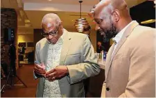  ?? Michael Wyke/Contributo­r ?? Astros manager Dusty Baker, left, signs a baseball for David Young before the start of a NAACP ceremony to honor Baker.
