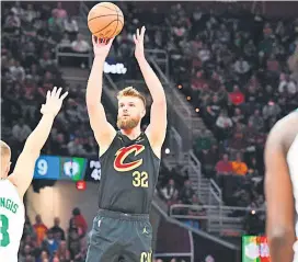  ?? — AFP photo ?? Wade shoots over Kristaps Porzingis of the Boston Celtics during the fourth quarter at Rocket Mortgage Fieldhouse in Cleveland, Ohio.