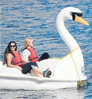  ??  ?? Summer swansong...two friends enjoy a ride on a pedalo near Liverpool Docks