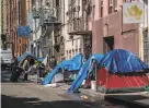  ?? Nick Otto / Special to The Chronicle ?? A row of tents in the Tenderloin. California has the highest poverty rate in the country when housing costs are considered.