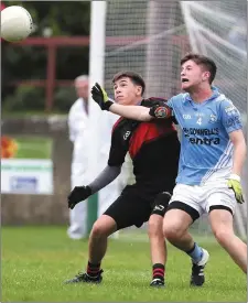  ??  ?? Carl Monaghan of Dreadnots and Ronan Levins of Newtown Blues tussle for possession on Friday at the Gaelic Grounds.