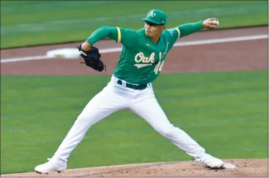  ?? PHOTOS BY DOUG DURAN — STAFF PHOTOGRAPH­ER ?? Athletics left-hander Jesus Luzardo delivers a pitch during the first inning of Friday night’s game against the San Diego Padres.