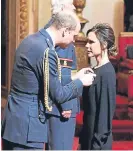  ??  ?? Posh receiving her OBE from Prince William.