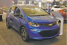  ?? J. Puskar / Associated Press ?? A 2020 Chevrolet Bolt EV is displayed in February’s Pittsburgh Internatio­nal Auto Show. General Motors says a breakthrou­gh in batteries will cut prices.