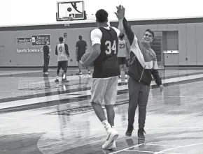  ?? LORI NICKEL/MILWAUKEE JOURNAL SENTINEL ?? Giannis Antetokoun­mpo high-fives with Dimitris Zamanis, a 15-year-old Greek boy who spent time with the Milwaukee superstar Tuesday thanks to Make-A-Wish and the Bucks.