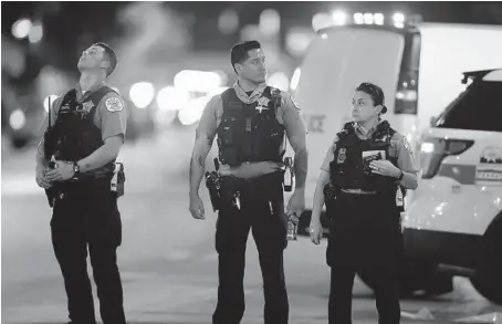  ?? CHRIS SWEDA/CHICAGO TRIBUNE ?? Chicago police work the scene near where two officers were shot at 63rd Street and Bell Avenue in Chicago on Aug. 7.