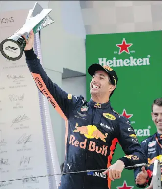  ?? ANDY WONG/THE ASSOCIATED PRESS ?? Red Bull driver Daniel Ricciardo raises his trophy after winning the Formula One Chinese Grand Prix at the Shanghai Internatio­nal Circuit on Sunday in Shanghai.