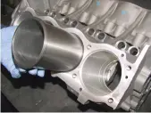  ??  ?? Crack solution
Even if the cylinder block cracks, this liner being fitted by ACR to a remanufact­ured V8 has an upper flange and lower seal that effectivel­y blocks any coolant leak path.