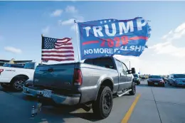  ?? CHARLIE NEIBERGALL/AP 2020 ?? Flags fly outside a Trump campaign rally in Dubuque, Iowa.
