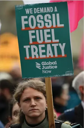  ?? Photo by JUSTIN TALLIS / AFP ?? An activist holds a placard during a protest march called by the climate change protest group Extinction Rebellion (XR) in London on February 28, 2024.