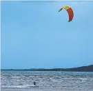  ?? Kenny Wallis takes advantage of the approachin­g cyclone to kite surf. ??