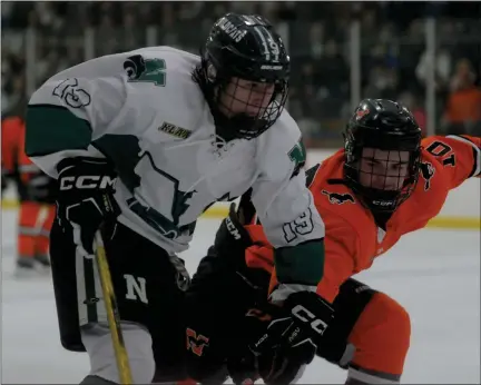  ?? PHOTOS BY KEN SWART — FOR MEDIANEWS GROUP ?? Novi’s Trevor Reed (19) tries to move around Northville’s Tommy Loebach (10) during the KLAA match-up played on Tuesday at the Novi Ice Arena. Reed had a goal for the Wildcats, but the Mustangs won the game 4-2.