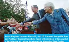  ??  ?? In this file photo taken on March 06, 1992 US President George HW Bush and First Lady Barbara Bush shake hands with members of the crowd at a ‘Bush/Quayle 92’ rally on the steps of the Mississipp­i State Capitol.