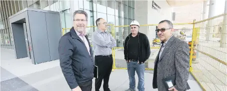  ??  ?? City engineer Mark Winterton, left, CAO Onorio Colucci, Tony Lapico of Oscar Constructi­on and project manager Wadah Al-Yassiri, right, outside city hall.