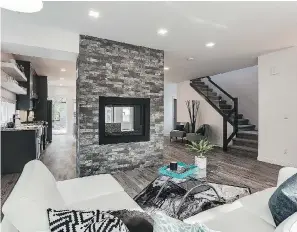  ??  ?? This infill build on 10th Avenue North features an open-concept main floor. A two-way floor-toceiling gas fireplace divides the space between the living room and the kitchen/dining area.