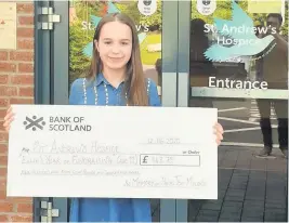  ??  ?? Fabulous fundraiser The youngster delivers her £948.75 donation to the hospice